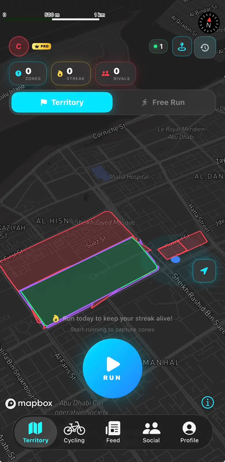 Own-it live city map with a claimed territory filled in green, a rival territory outlined in red, and the run button ready over central Abu Dhabi.